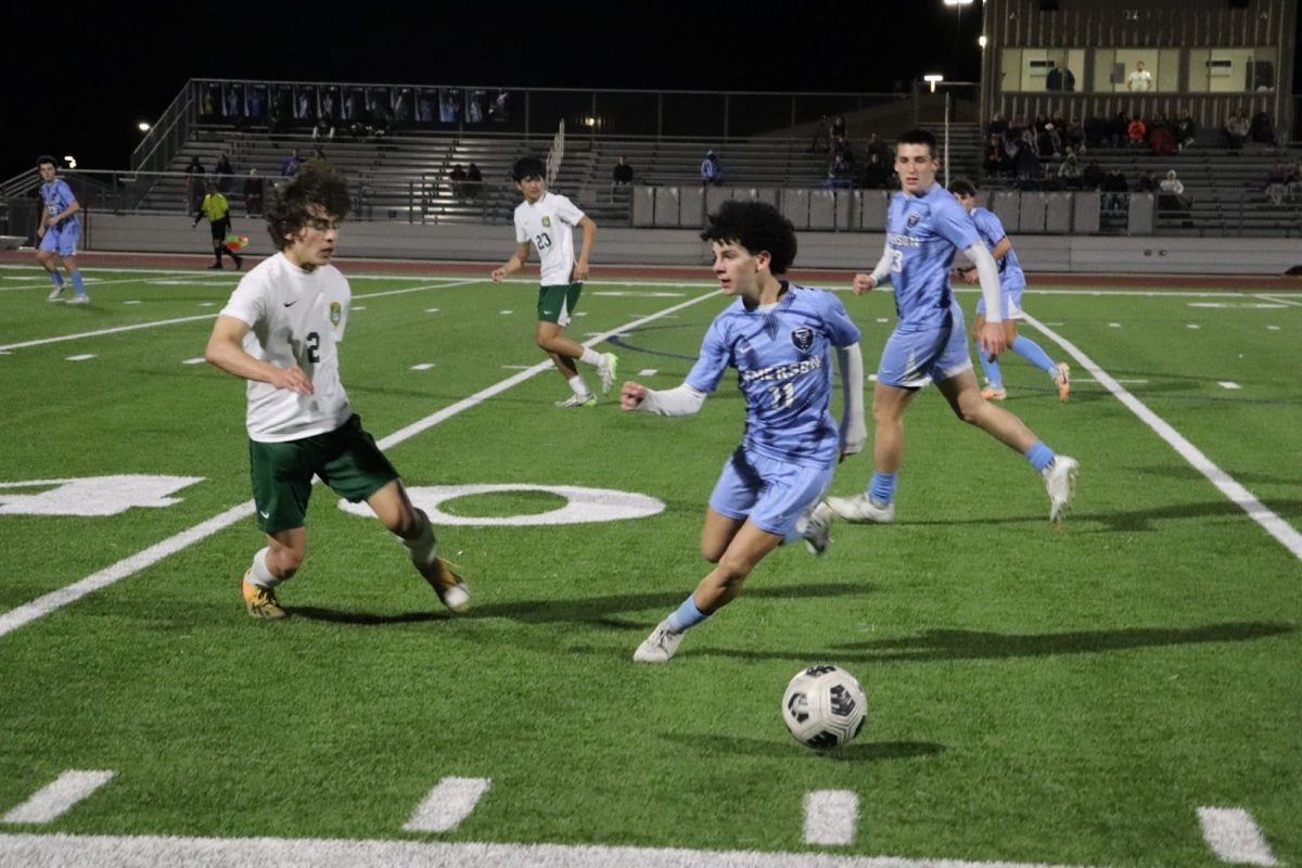  Sophomore John Pacheco turns to the ball, trying to stop the ball from progressing near our goal.