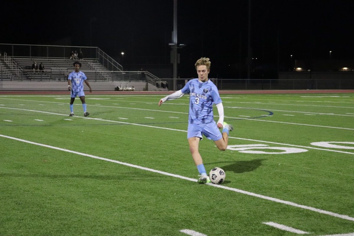 Sophomore Ethan McCullough gains control of the ball and searches for a chance to pass to his teammate.