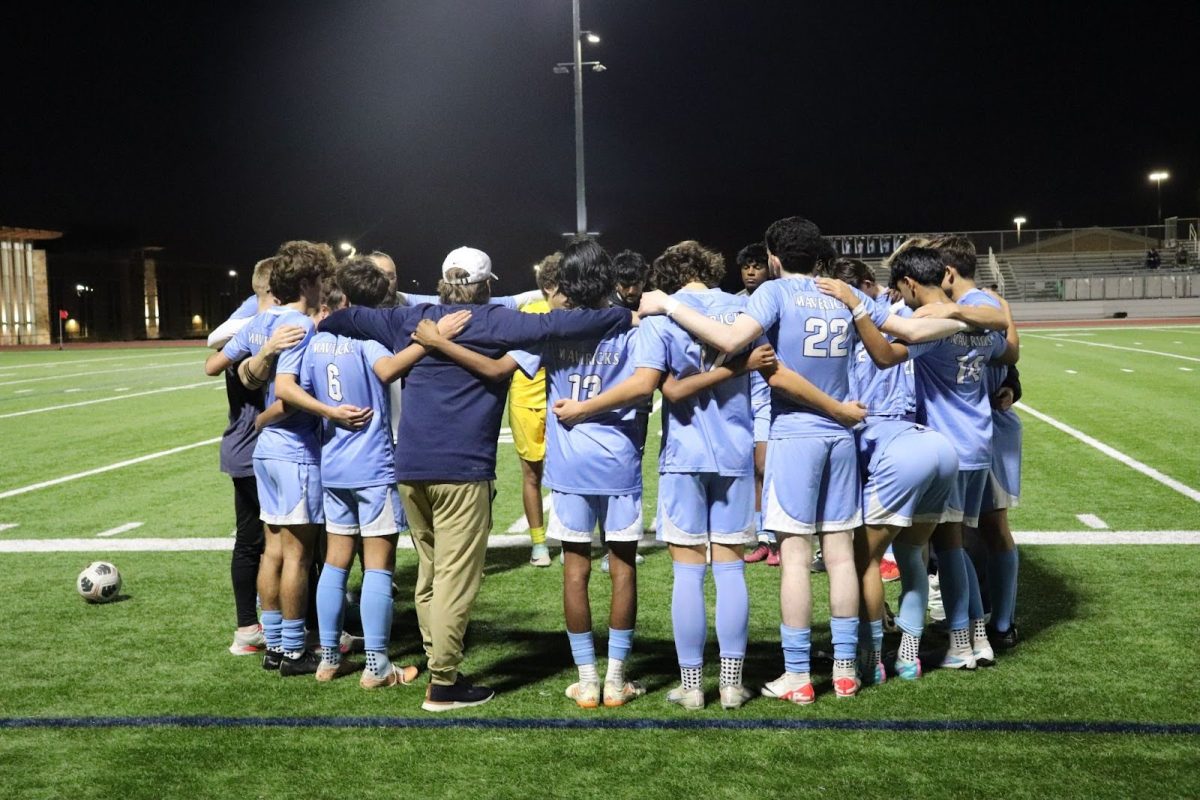 The Boys Soccer team huddles during the game on February 20.