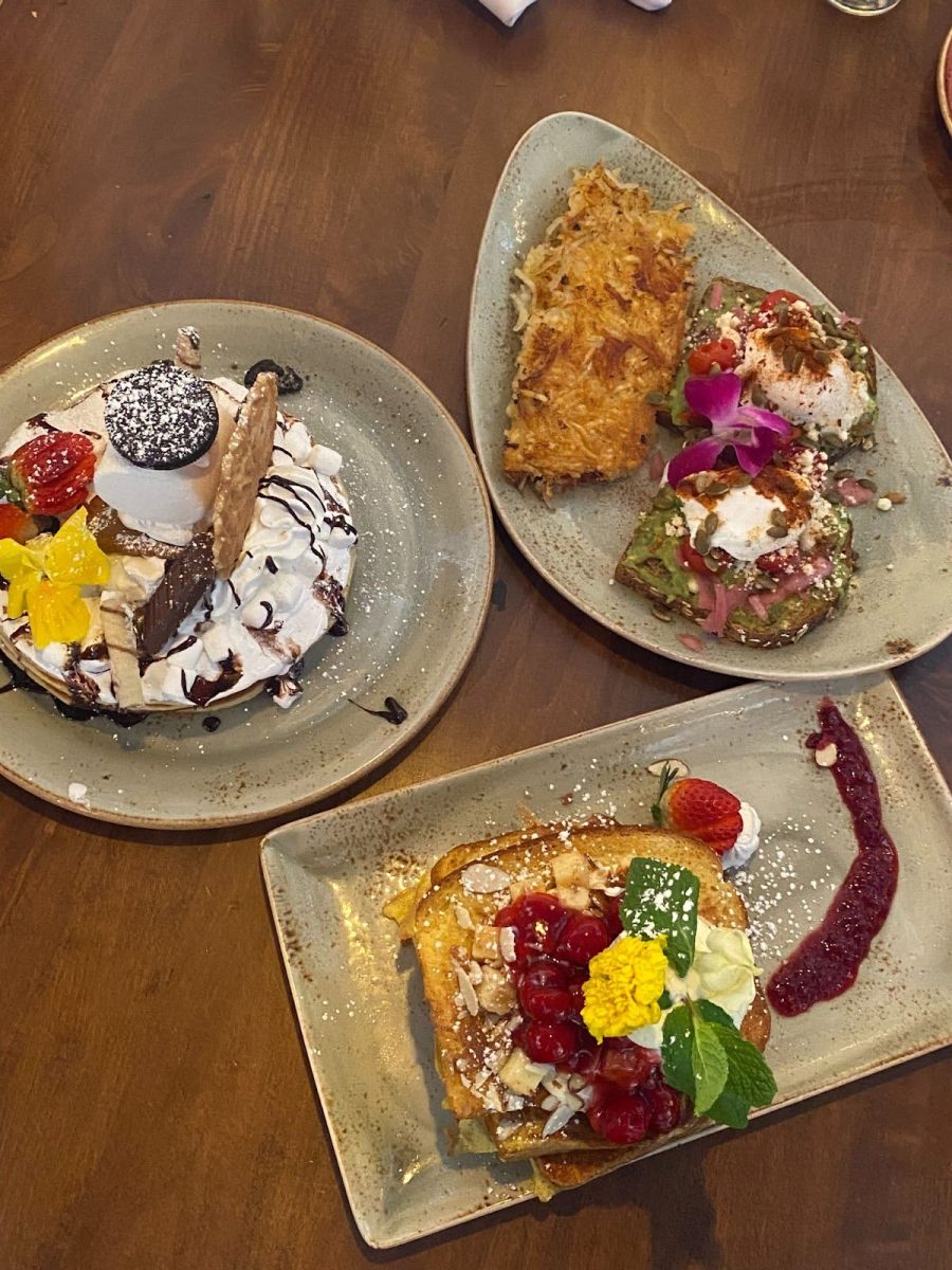 A colorful array of breakfast foods from Fairview Farmers including the cherry almond french toast and OG avocado toast. 
