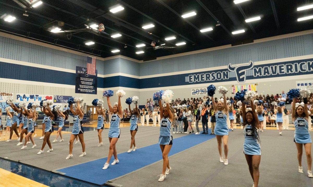 The cheer squad performs a routine in anticipation for the first football game of the school year.