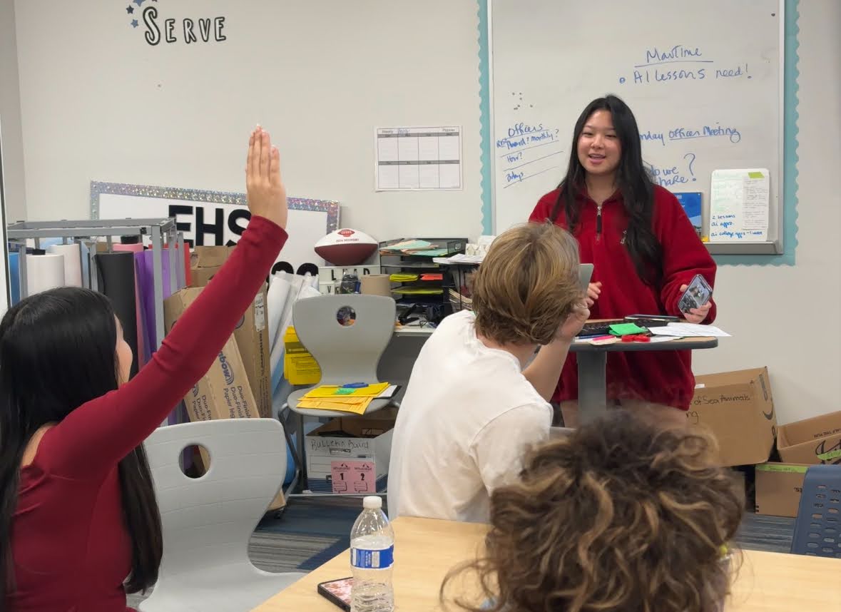 Senior Class Co-President Chloe Jung, 12, leads a discussion with her homecoming committee. 