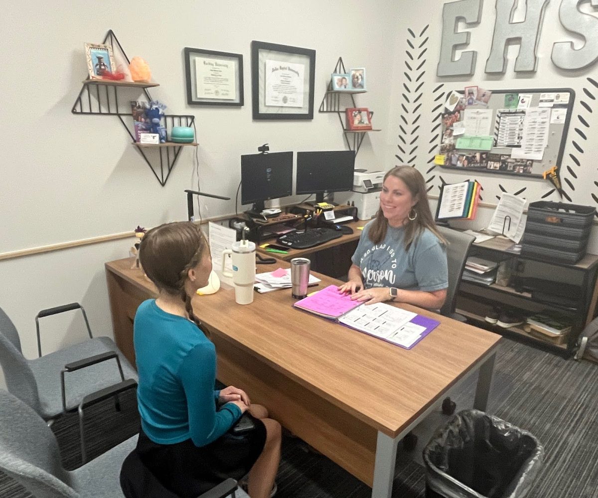 Counselor Jamie Manley discusses college options with a current junior. She dedicates her time to serving the students and making life easier for them. 