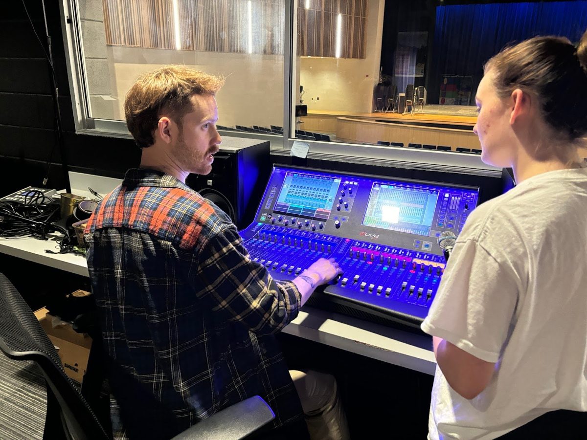 Loub teaches Faith Quave, 12,  the ins and outs of operating the lightboard.