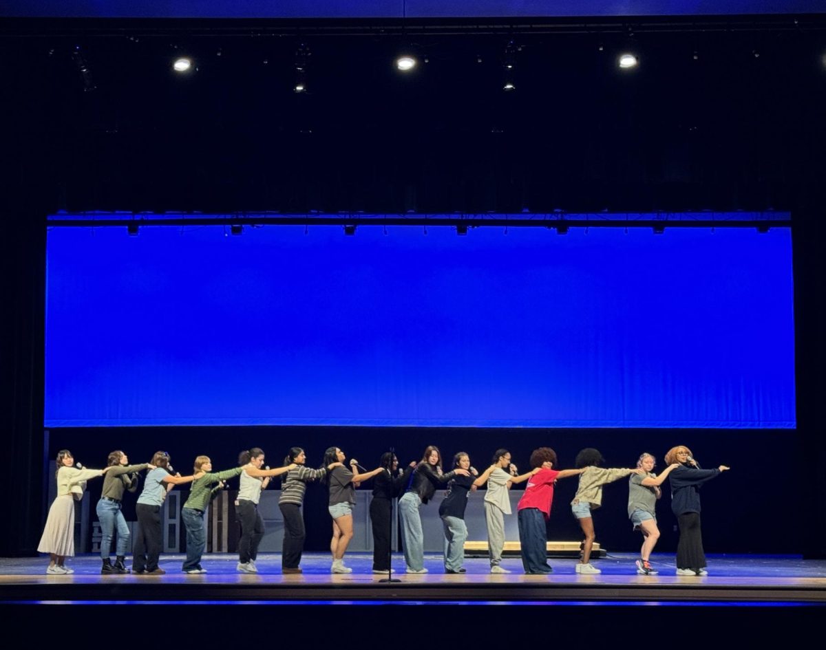 The chorale team practices their group performance choreography for the upcoming show.