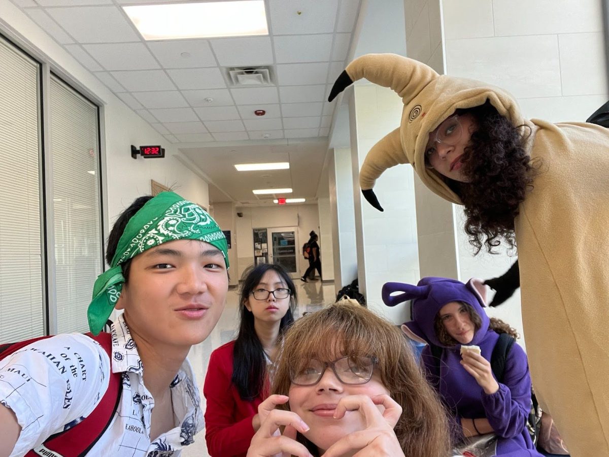 Jasson Kwan, 9, poses with his friends to show off their Halloween costumes.