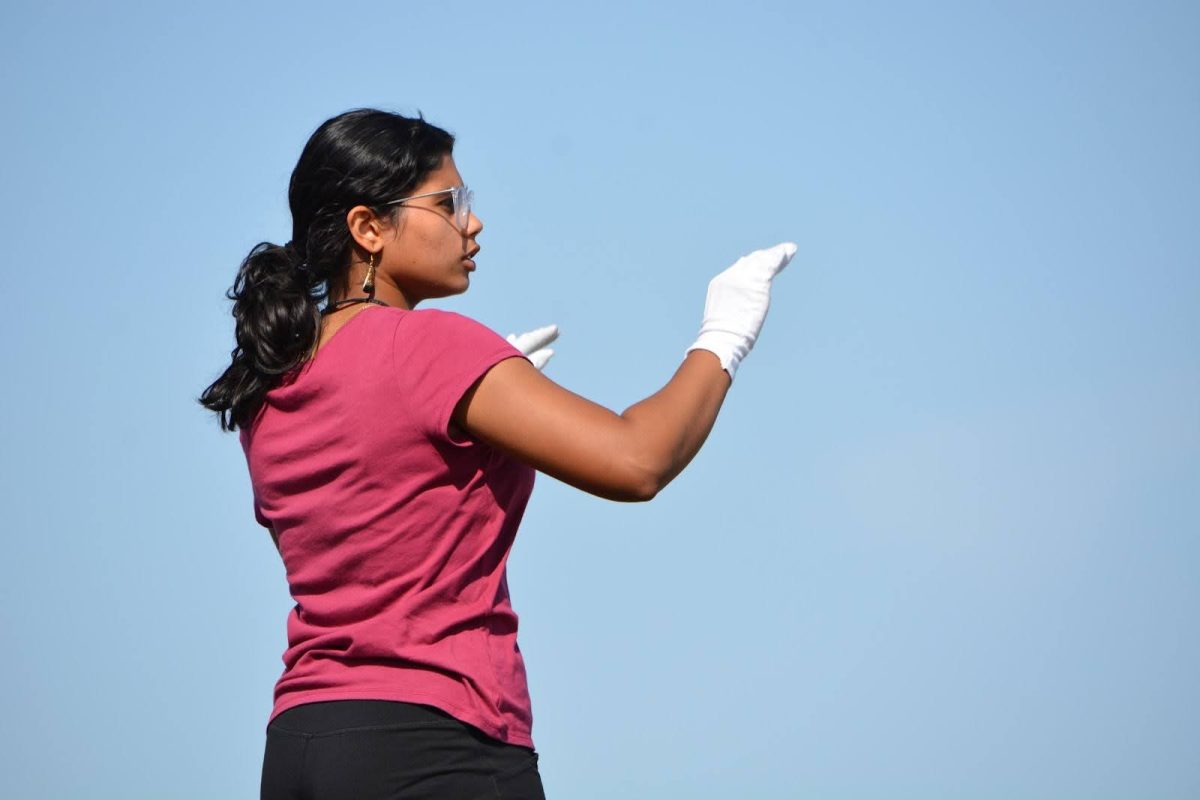 Head Drum Major, Keshika Sharma, 12, conducting during a rehearsal.