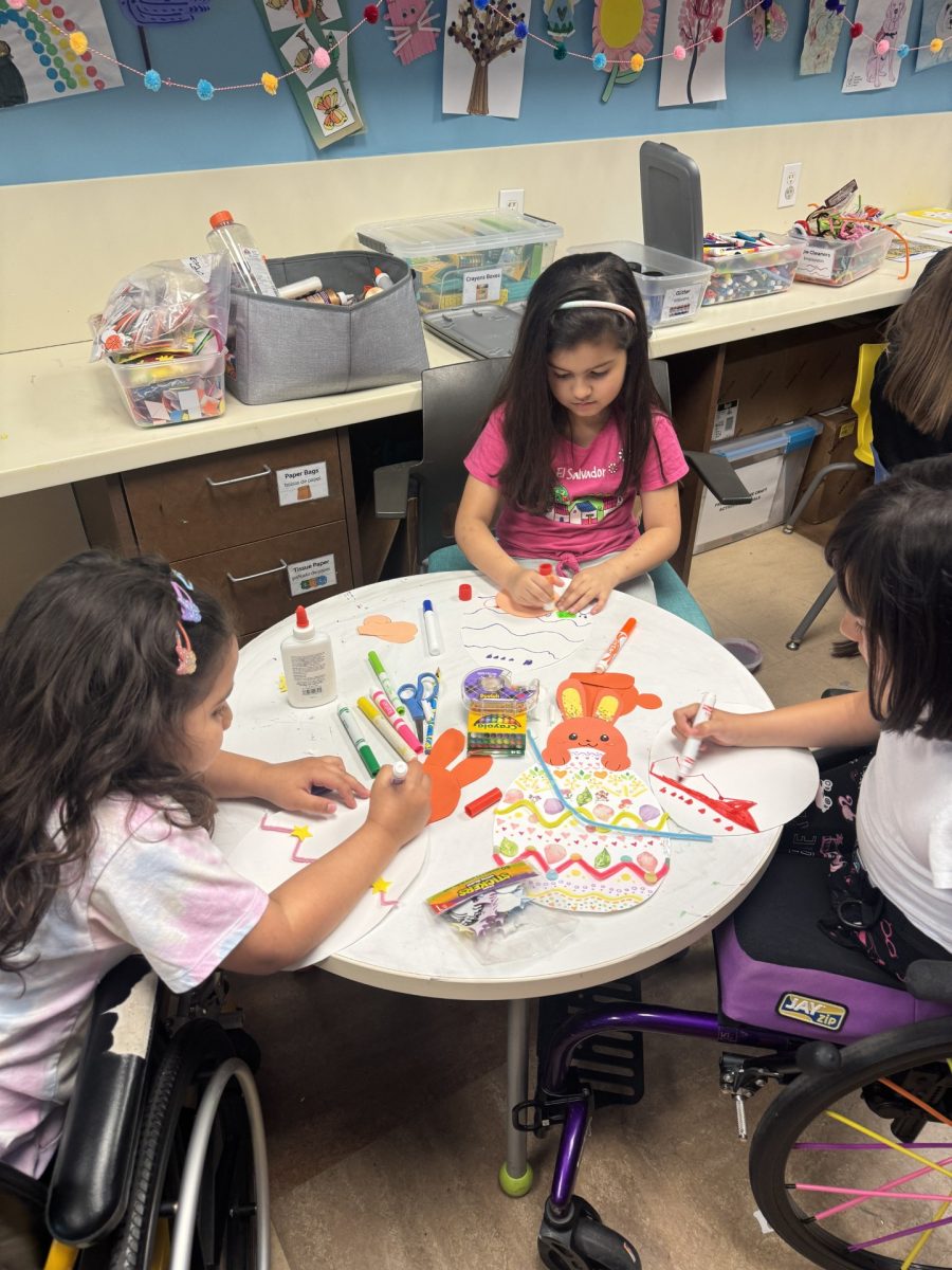 Children complete the art kits at the Ronald McDonald House.