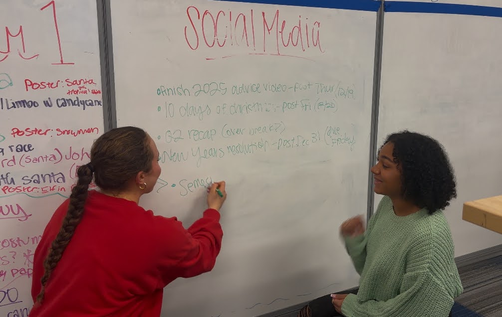 Madison Mintz collaborates with fellow maverick leadership officer Addisyn Wimberly, 11 , on a quarter recap with plans of action for the coming year.