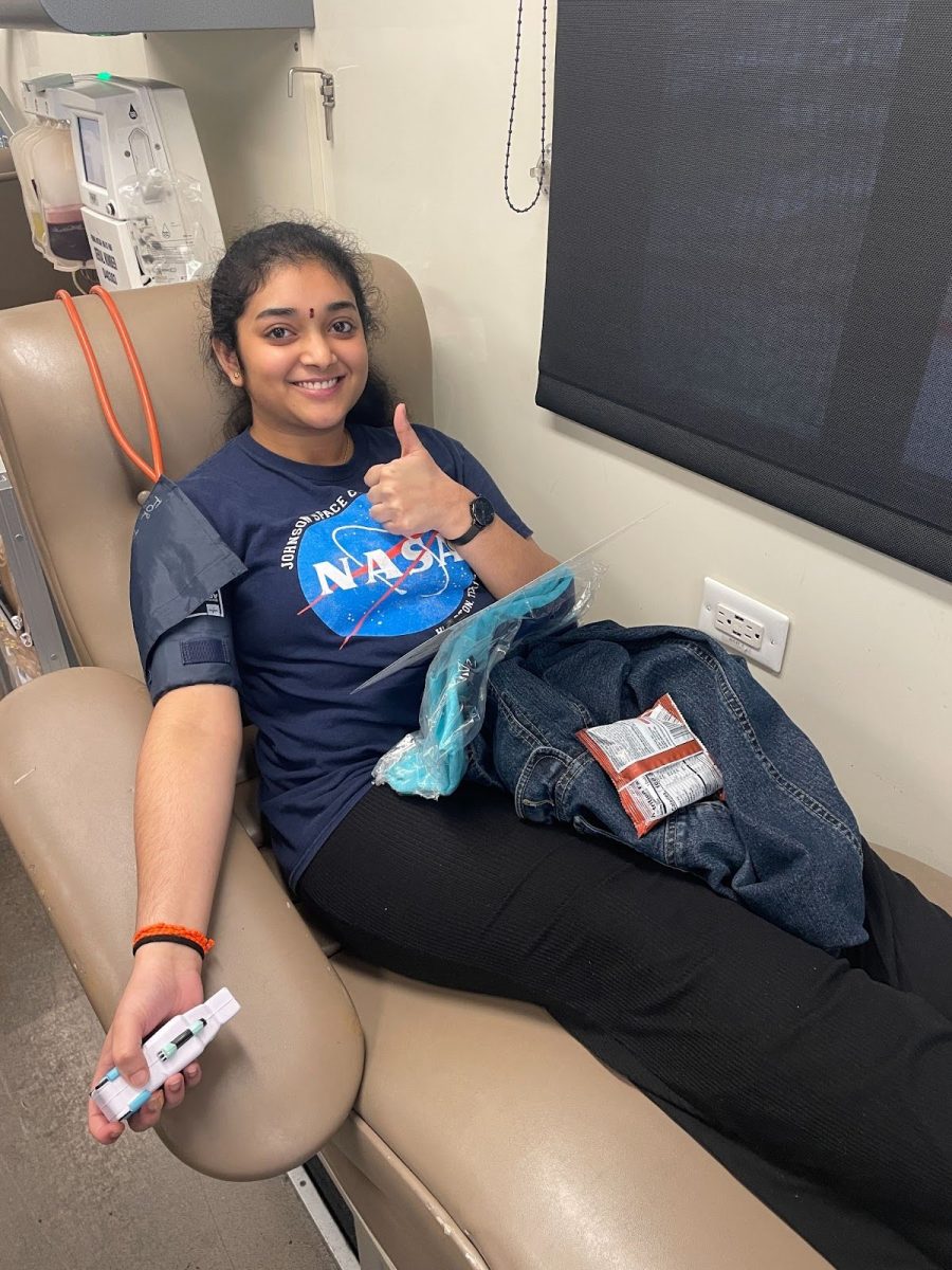 Senior Srinidhi Marrivada prepares to donate blood in a Carter BloodCare bus.