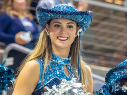 Ava McCall, 12, cheers for the Emerson Mavericks at a football game.