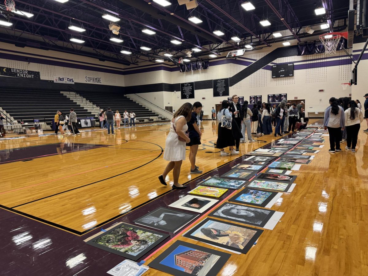 Medal recipients' artwork are on display in the gym.