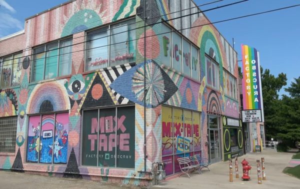 The outside of the Mix-tape building as well as the Factory Obscura. The building is completely covered with murals from different artists as well as a mix tape window near the entrance, which lights up and plays music during the night. 