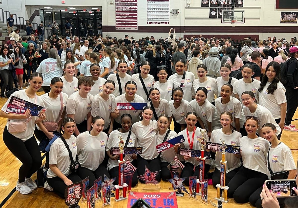 The Majestics pose with their trophies at the American Dance/Drill Team competition awards ceremony.