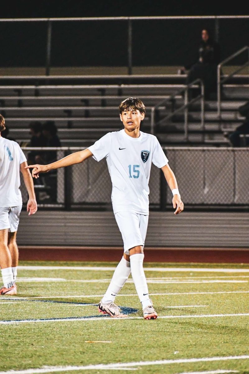 Paxton Ancheta directs a teammate during an Emerson soccer game (Jonathan Saavedra, 9)