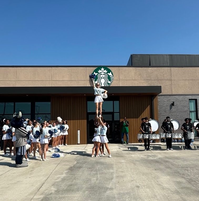 Emerson Cheer stunted and cheered to celebrate the grand opening of the new Starbucks.