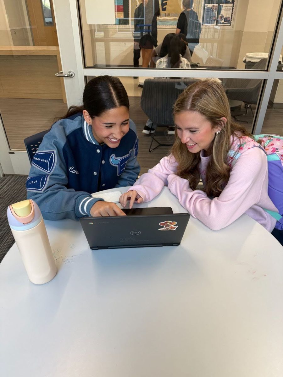 Carlota Ferrer, 10, and Emma Heinke, 12, analyze responses from students.