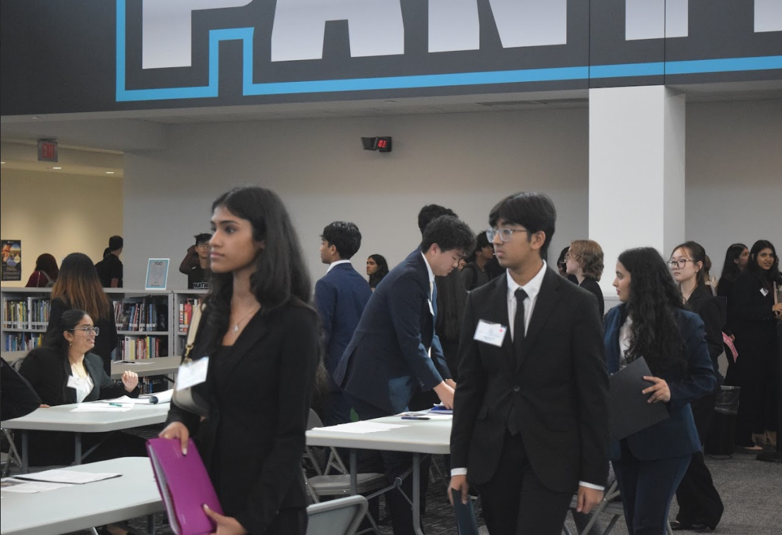 Jyotika Sadani, 12, and Mithil Bhansali, 11, walking to their professional interviews (Altizer Wendy, Lone Star ISM teacher). 
