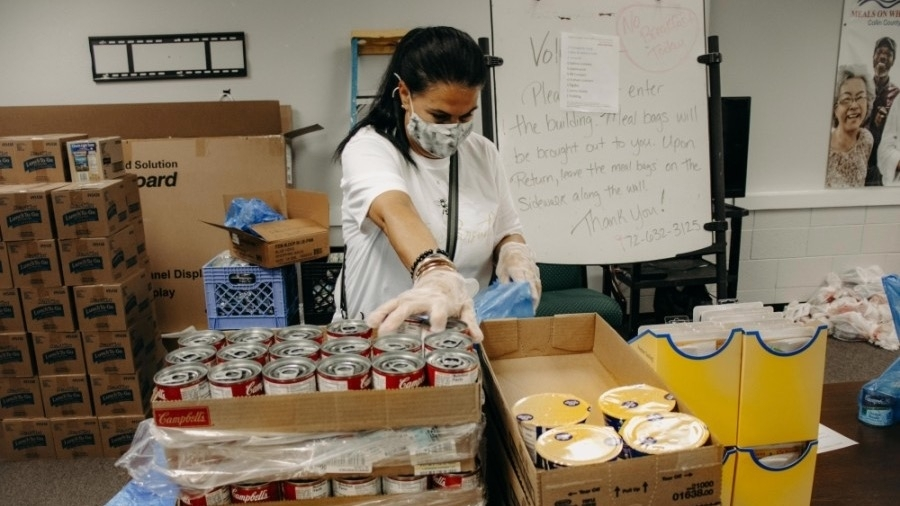 Volunteer worker begins making food orders for those in need(Community Impact).
