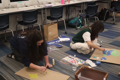 Emily Clemens, 10, and Yena Nam, 12, making decorations for the The Charge booth