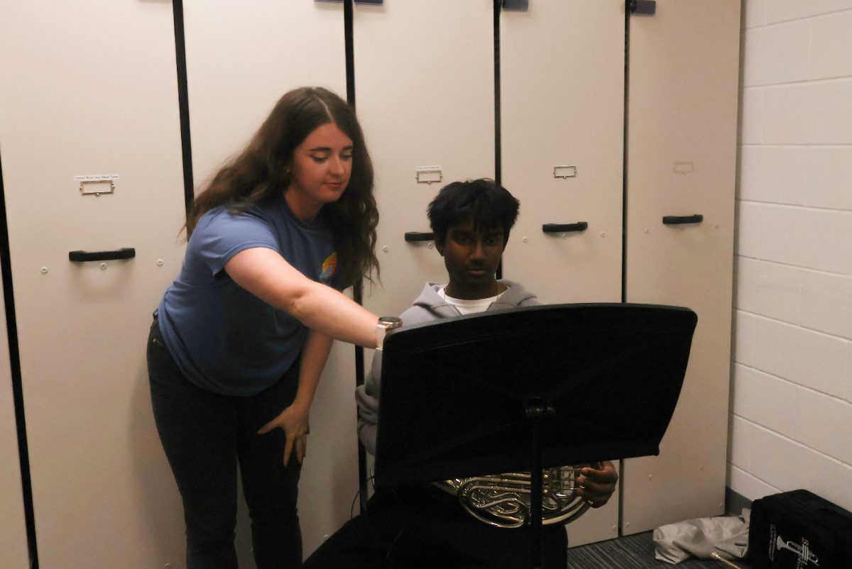 Kelsie Dunham teaches Rithik Nathan,10, the sheet music.