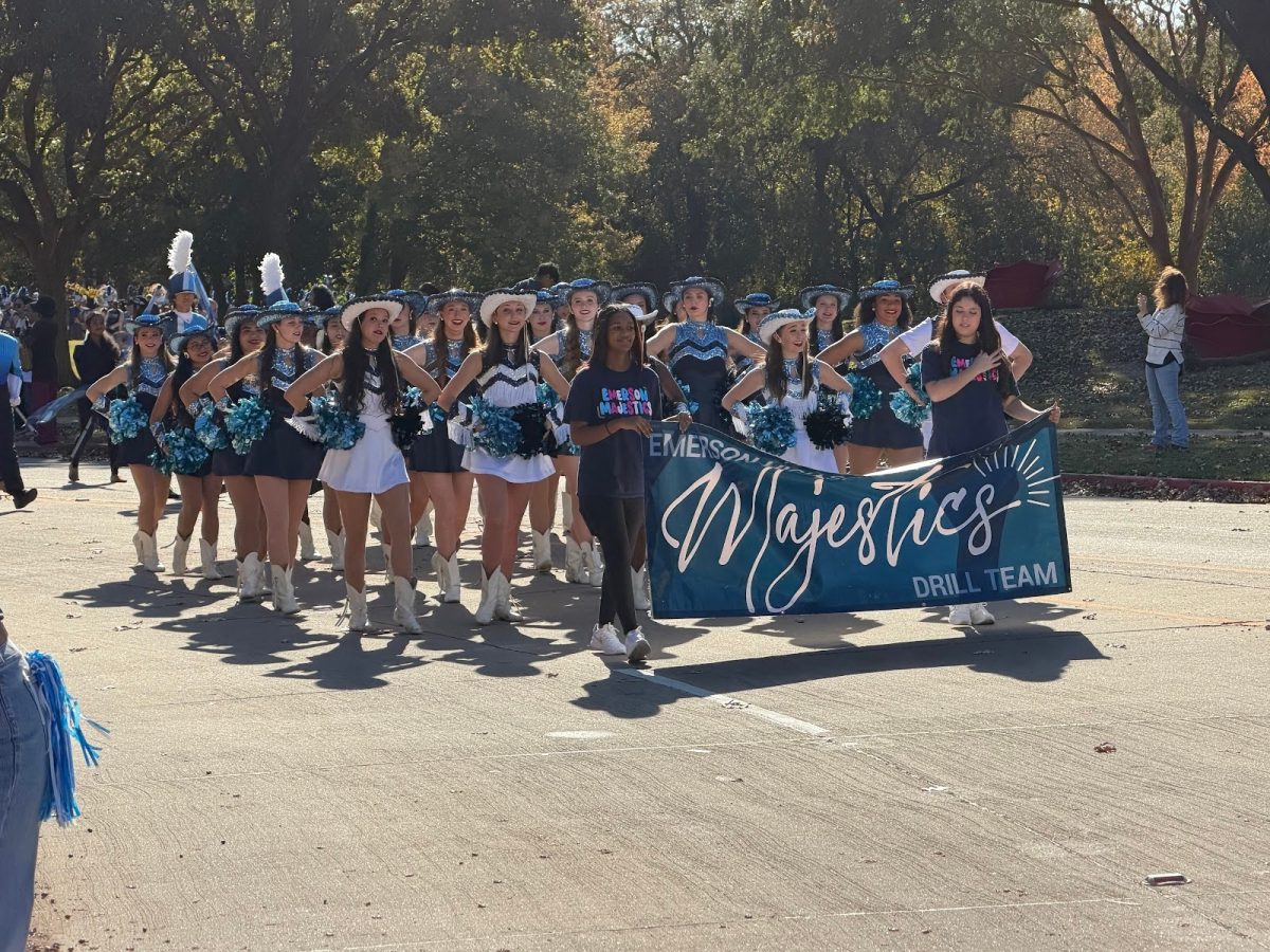 The Majestics cheer while walking in the parade (David Lessner). 