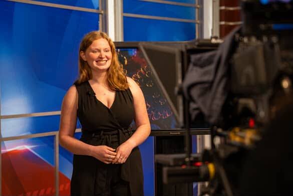 Isabelle Smith steps in front of the camera, anchoring the news with confidence and professionalism.