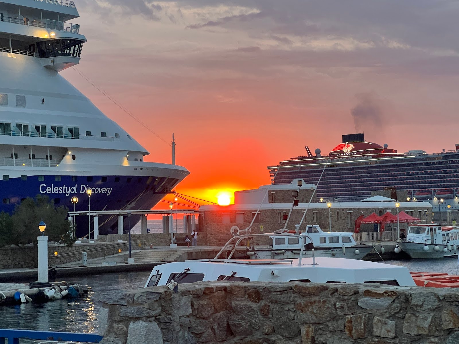 Vibrant views of the sunset by the cruise ships in Mykonos