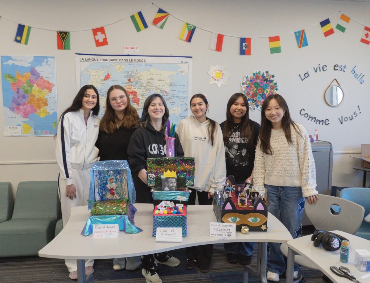 French 3 students displaying their Mardi Gras float projects (Molly Koshatka).
