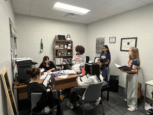 The varsity women’s choir, Chorale, having a sectional to prepare for UIL .