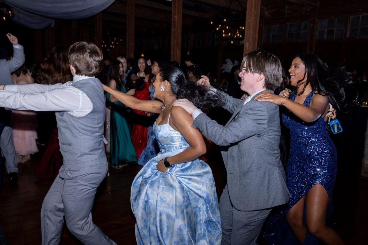 Students join for a conga line in the excitement of the dance.